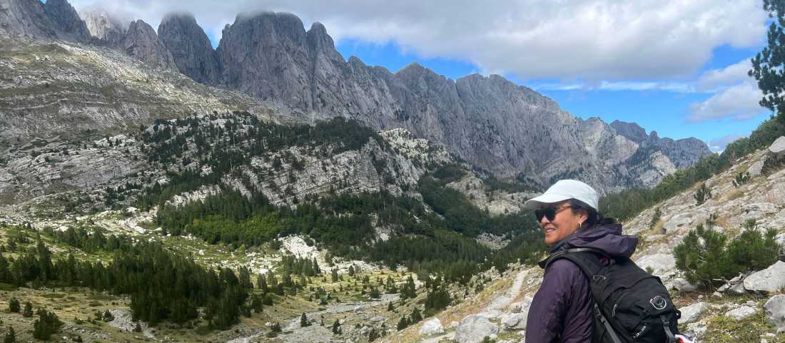 Hiker taking in the view in the Ropojana Valley Albania |  Kate Baker