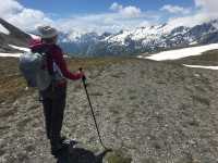 A hiker stopping to appreciate where they've just come from |  Allie Peden