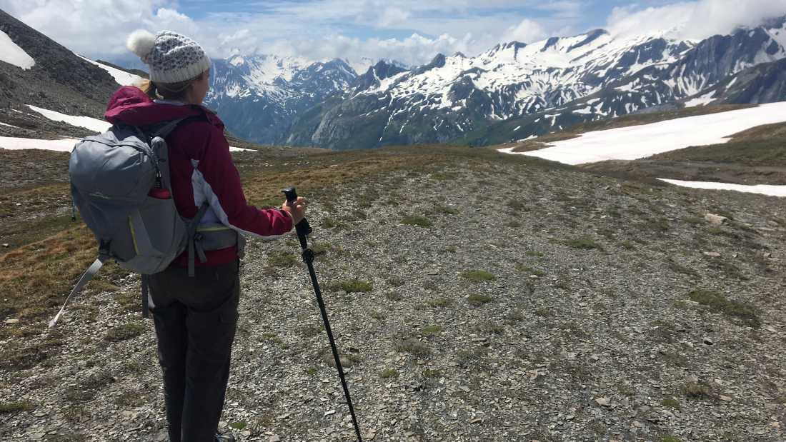 A hiker stopping to appreciate where they've just come from | Allie Peden