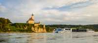 Barge crossing by Schonbuhel Castle on the Danube river