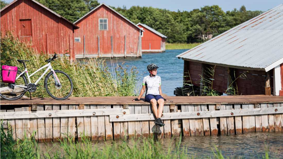 Cyclist taking a break while cycling between islands in Finland