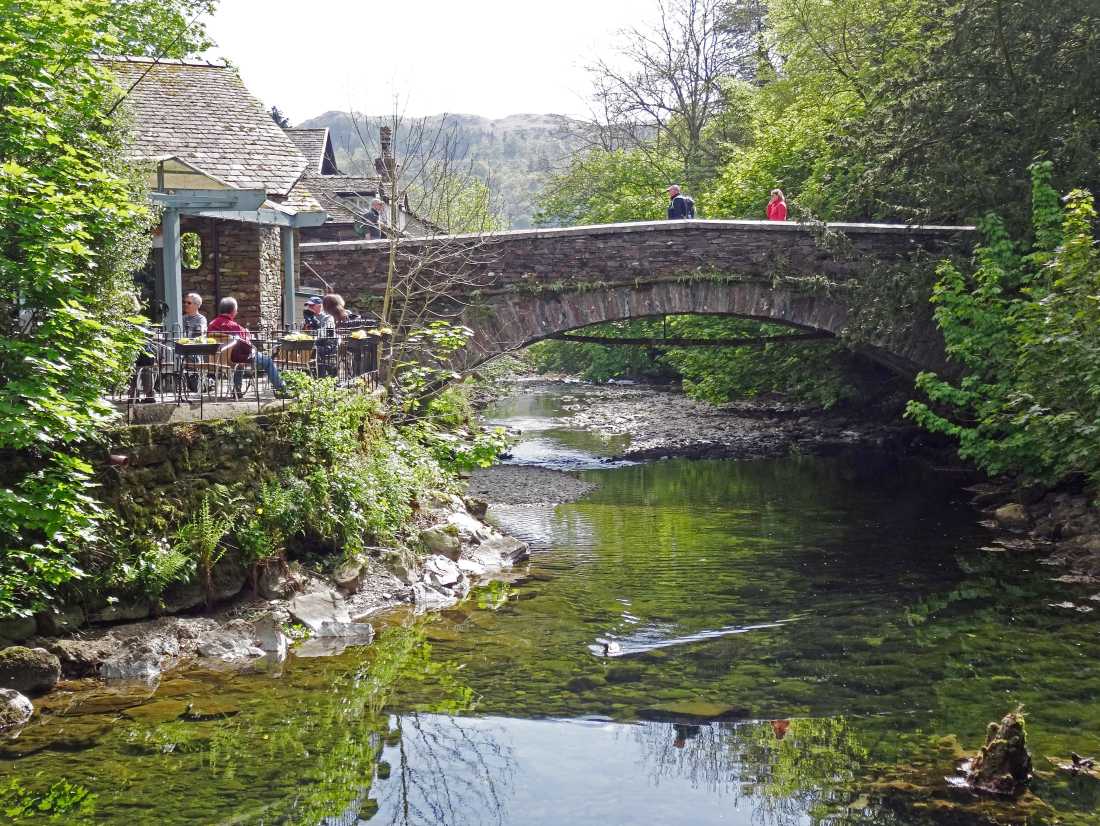 Walkers taking a rest at Grasmere Bridge on the Coast to Coast trail | John Millen